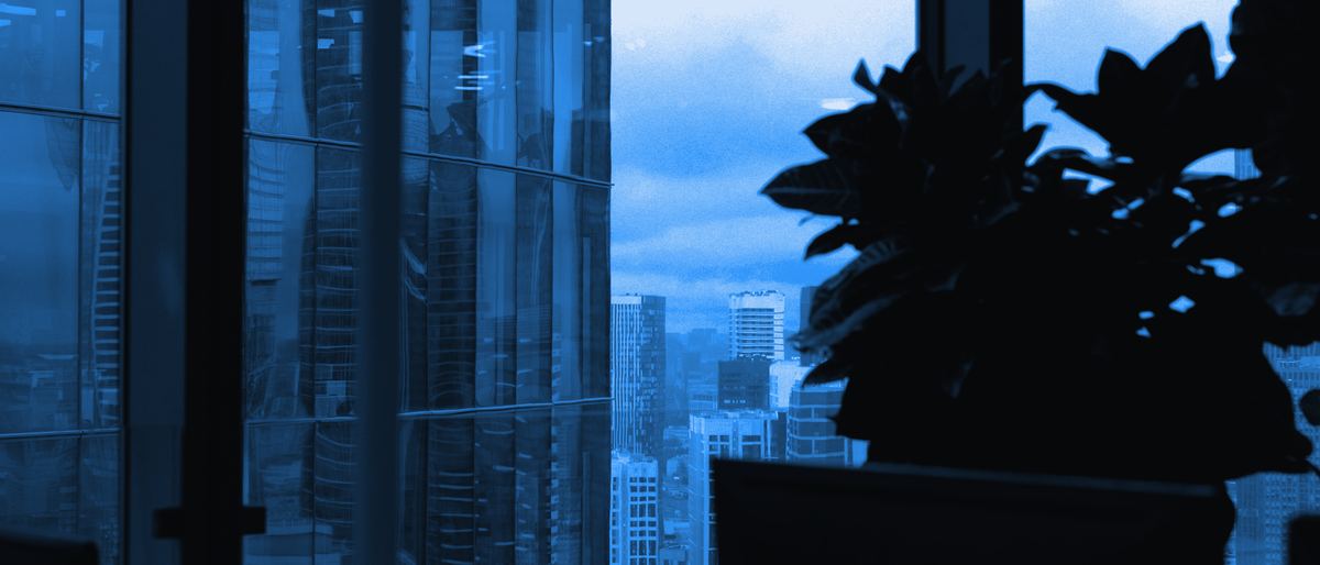 A modern office window overlooking a city skyline